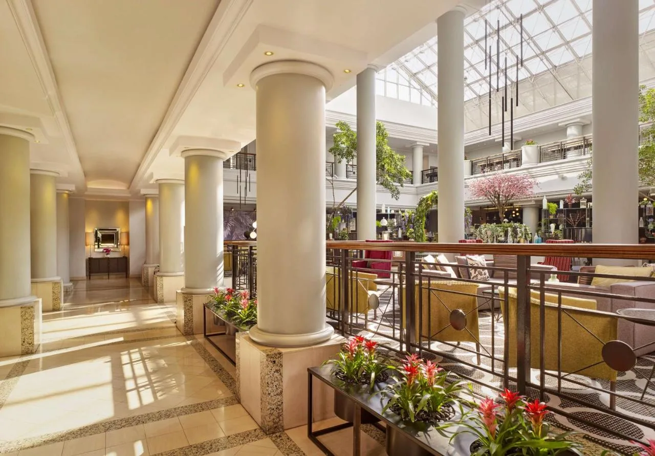 a lobby with columns and flowers in a building at Hyatt Regency Birmingham in Birmingham