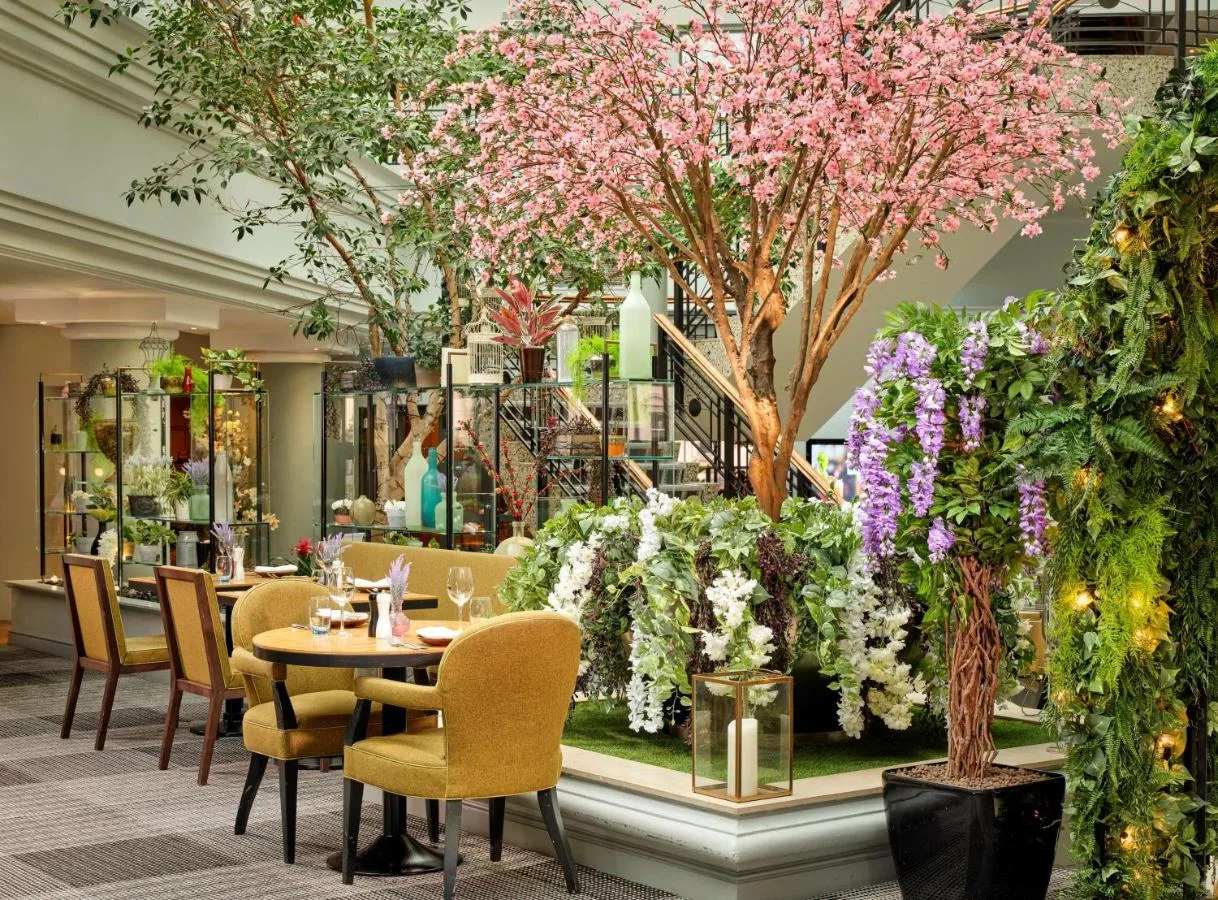a restaurant with a table and chairs and trees at Hyatt Regency Birmingham in Birmingham