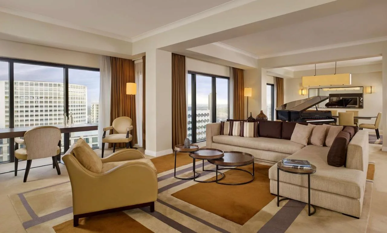 a living room with a couch and a piano at Hyatt Regency Birmingham in Birmingham